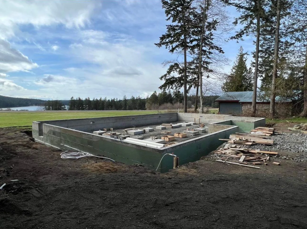 A new concrete foundation poured on a San Juan Islands waterfront lot